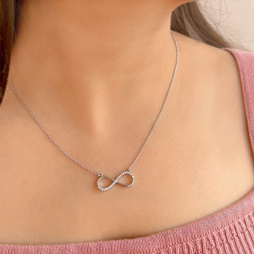 Model wearing Elegant silver infinity pendant necklace with fish clasp.