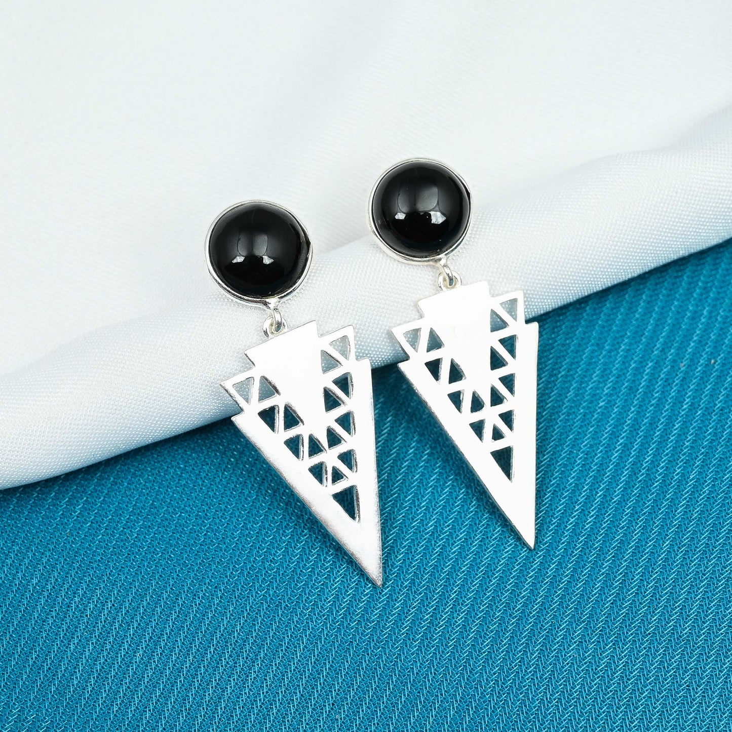 Handcrafted silver earrings showcasing the beauty of black onyx gemstones in bezel settings.